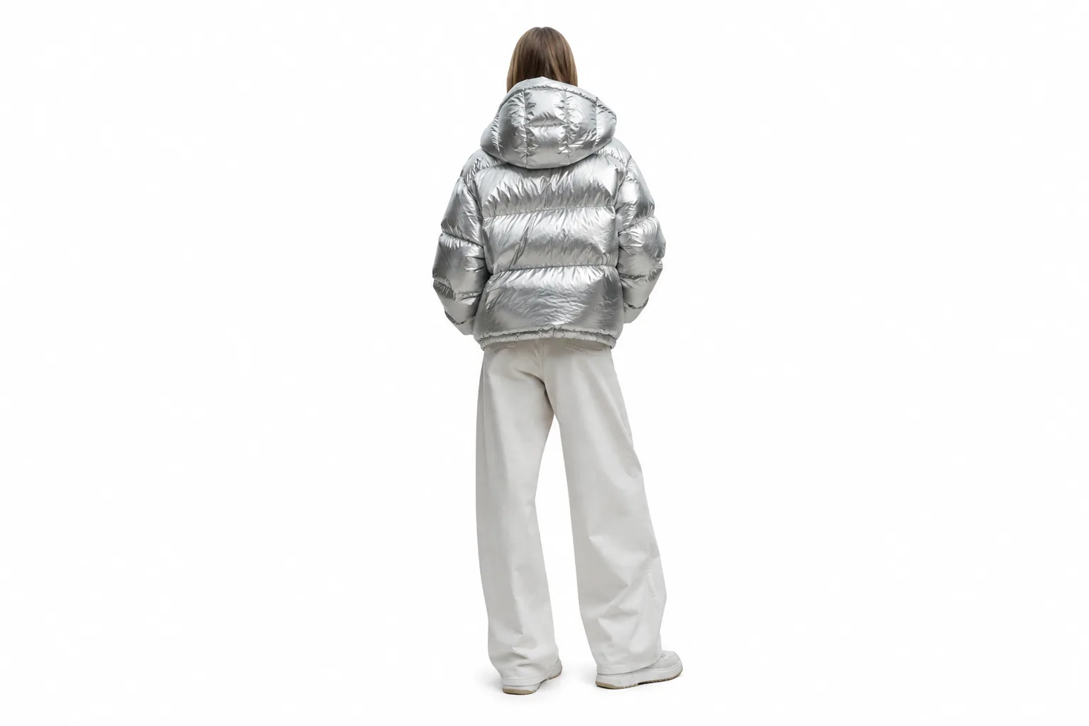streetwear model in metallic puffer jacket standing in brutalist concrete hallway, studio strobe lighting